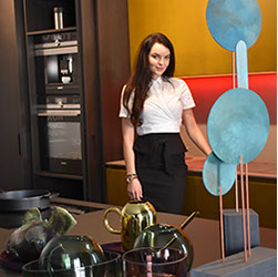 Hostess in a designer kitchen showroom display with built-in appliances &mdash; showroom event staff in New York