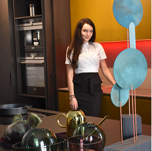 Hostess in a designer kitchen showroom display with built-in appliances &mdash; showroom event staff in New York