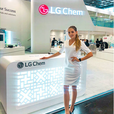 Trade show hostess assisting visitors at a New York exhibition booth